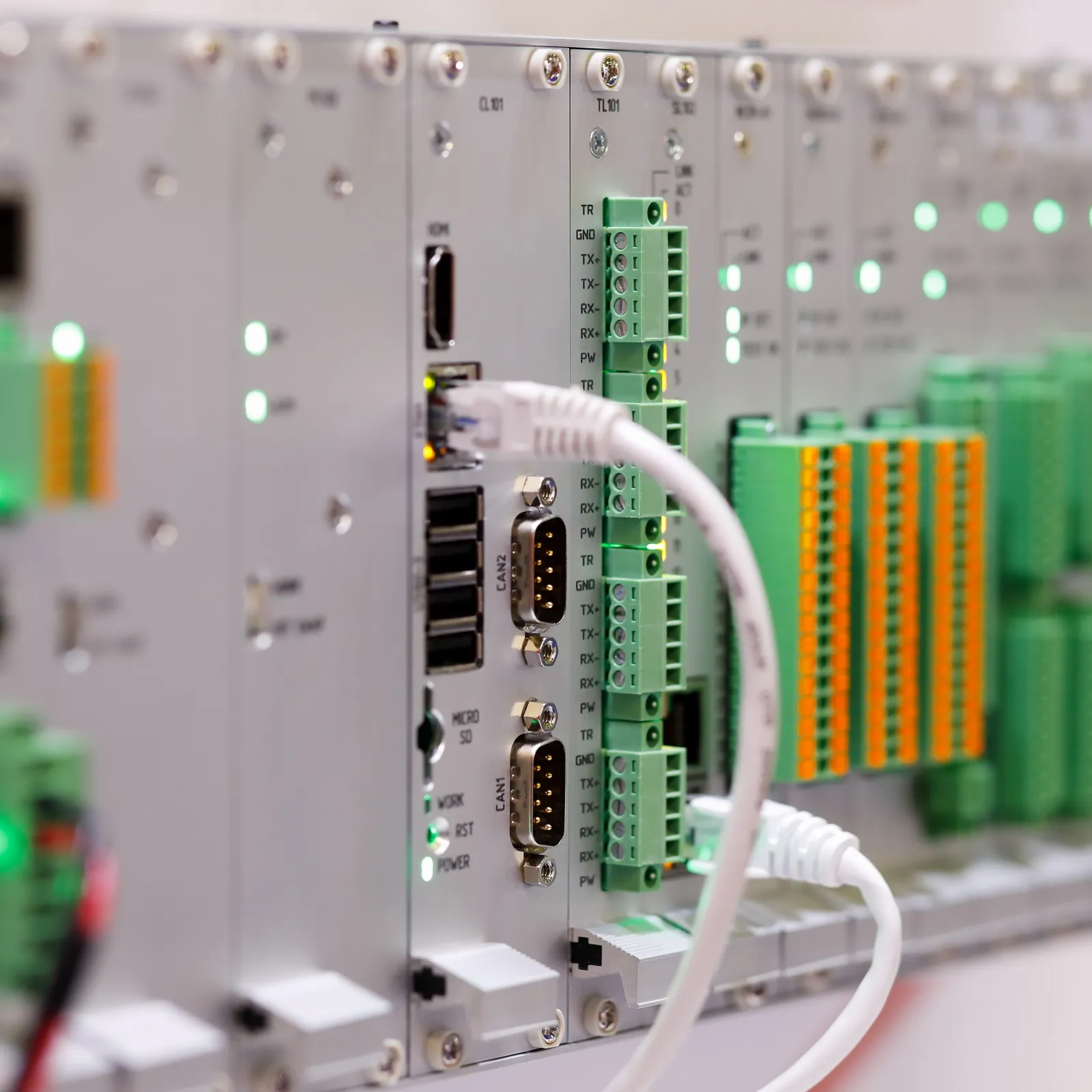 The back of a PLC rack with Ethernet cables connected directly to its modules